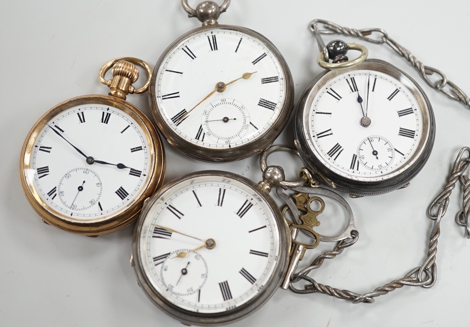 Three white metal open face pocket watches including two silver, one Waltham and a gold plated pocket watch.
